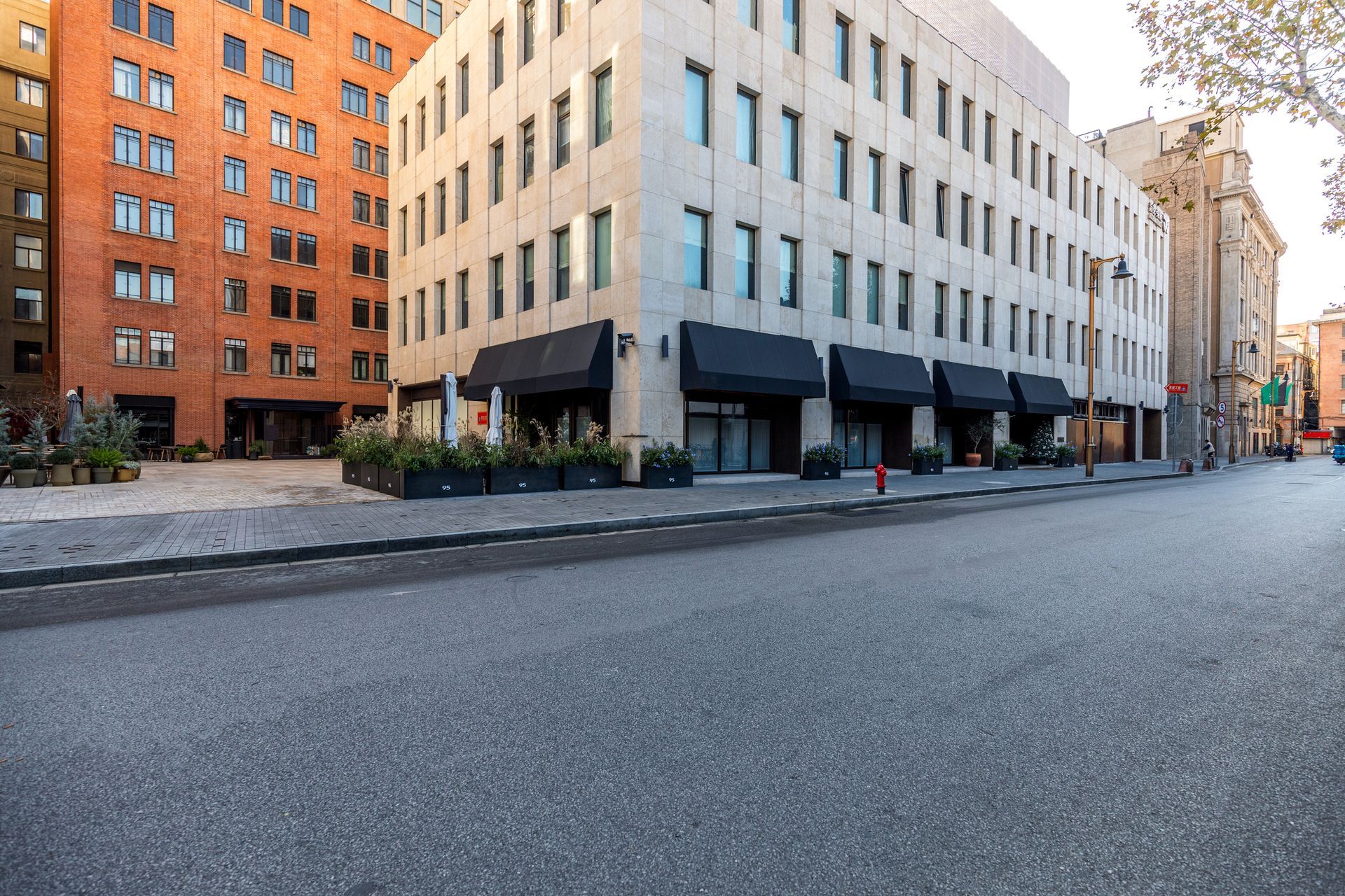 An empty city street with a large building in the background