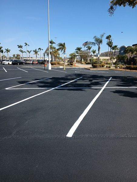 A parking lot with palm trees in the background