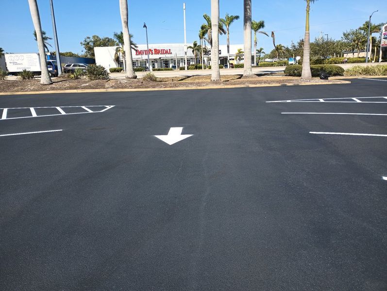 A parking lot with a white arrow pointing to the right