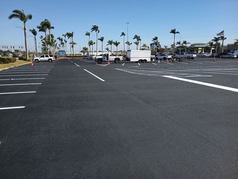 A parking lot with palm trees in the background