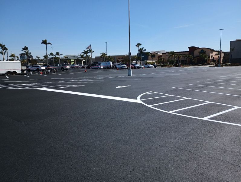 An empty parking lot with a white arrow pointing to the right