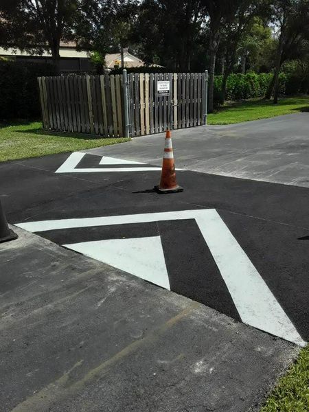 A traffic cone is sitting on the side of a road
