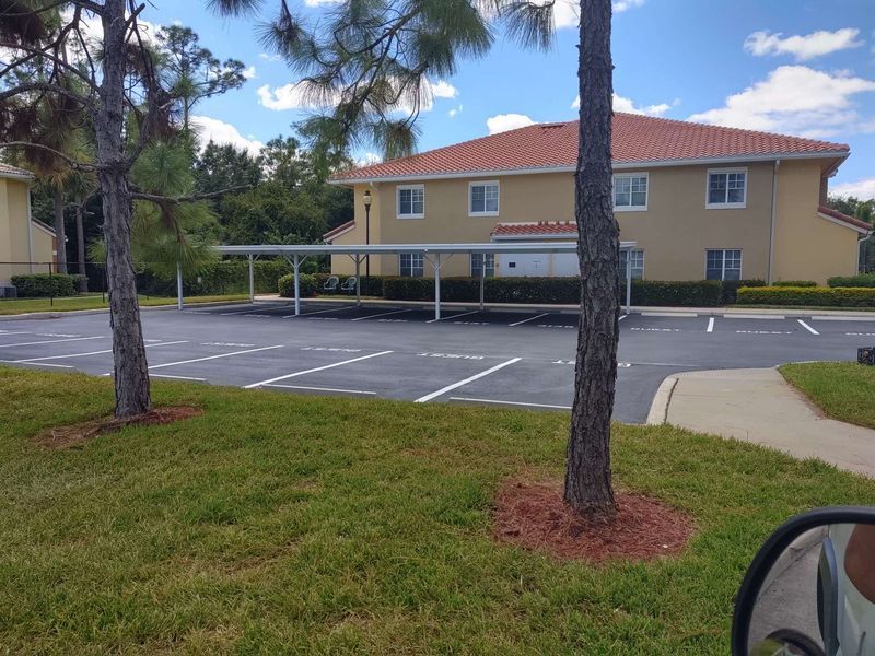 A building with a carport in front of it