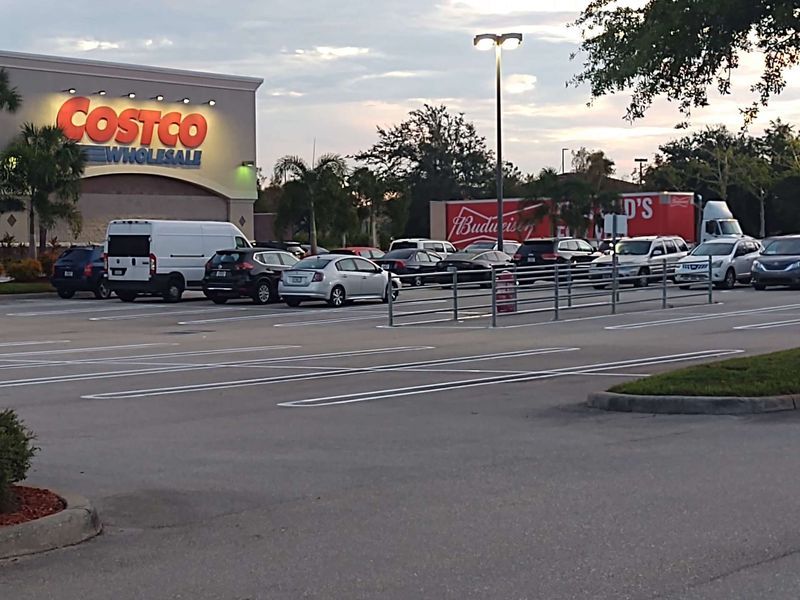 A lot of cars are parked in front of a costco store