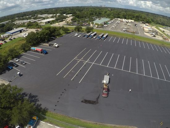 A parking lot with palm trees in the background