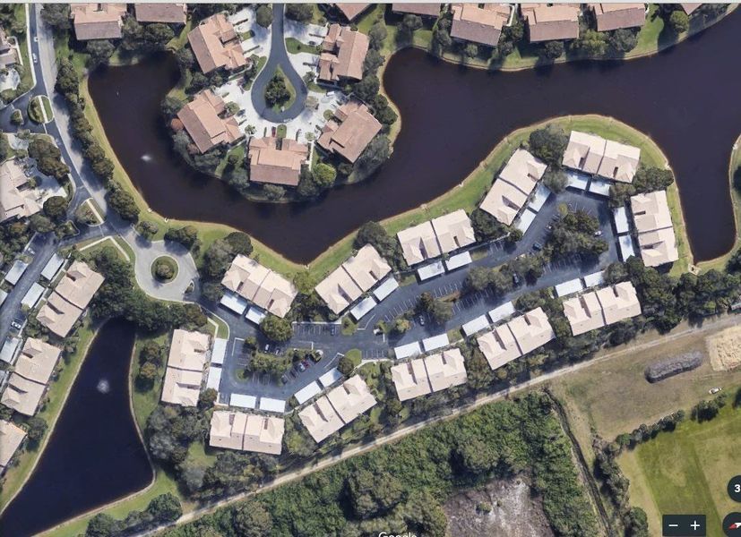 An aerial view of a residential area with lots of houses and trees