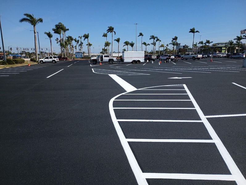 A parking lot with palm trees in the background