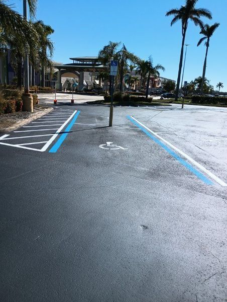 A handicapped parking spot in a parking lot with palm trees in the background
