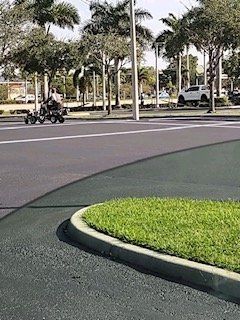 A person is riding a motorcycle down a street.
