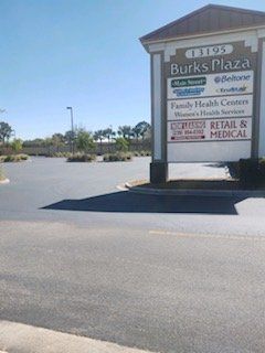A parking lot with a sign that says ' burks plaza ' on it