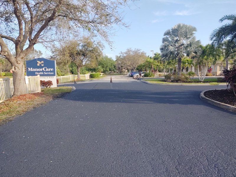 A road with a sign that says visitor care on it