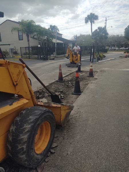 A yellow tractor is parked on the side of the road