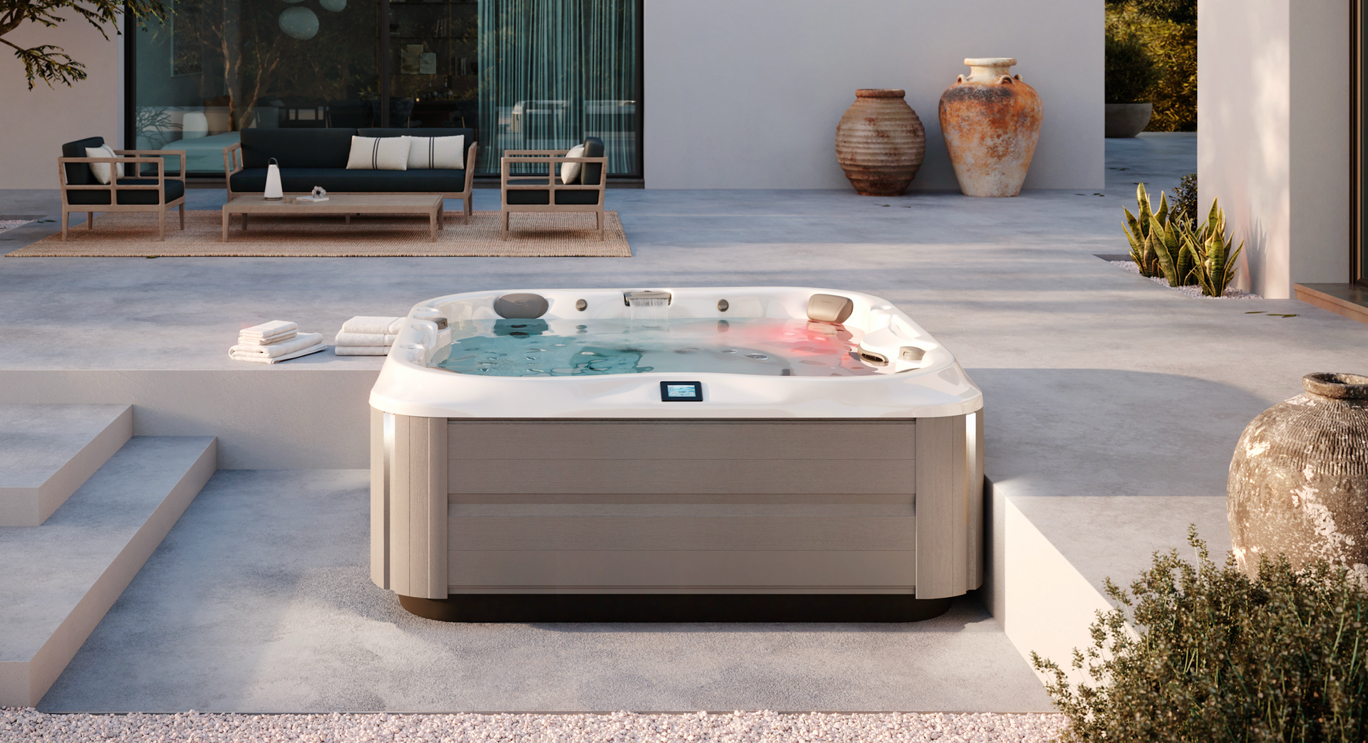 Un bain à remous est installé sur une terrasse à côté d'un mur de briques.