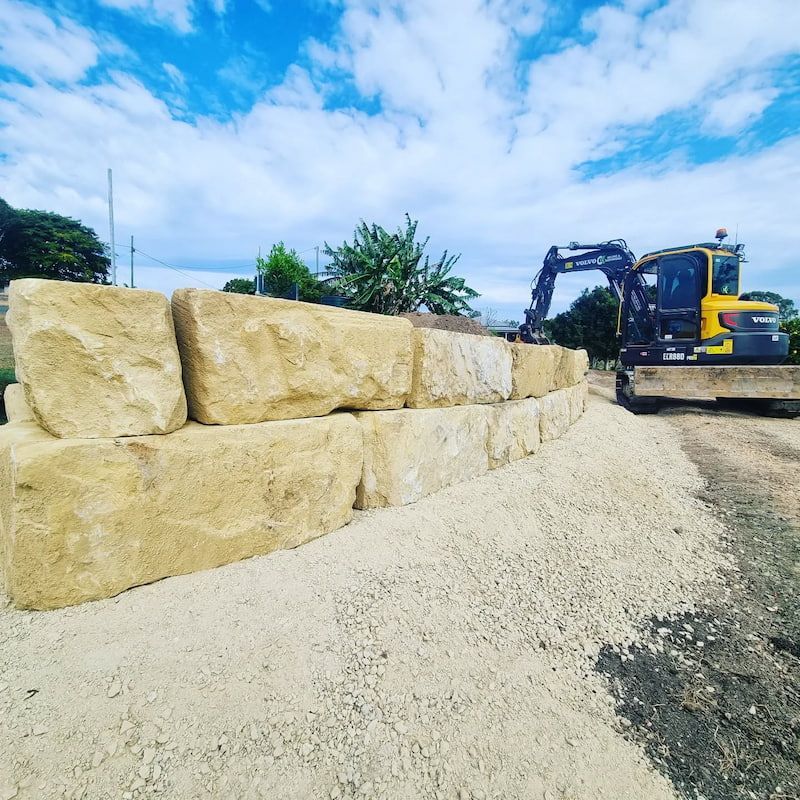 A Bulldozer Is Working on A Wall of Rocks — CK's Milling & Earthworks in Veteran, QLD