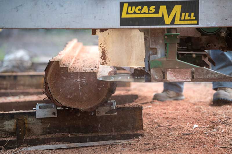 A Lucas Mill Machine Is Cutting a Log — CK's Milling & Earthworks in Bells Bridge, QLD