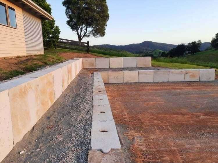 A Concrete Wall Is Being Built in Front of A House — CK's Milling & Earthworks in Pie Creek, QLD