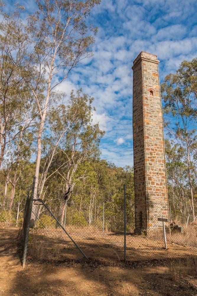 A Wooden Fence Surrounds a Grassy Field Next to A Road — CK's Milling & Earthworks in Kilkivian, QLD