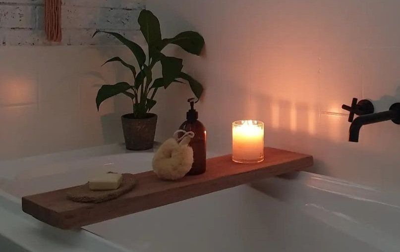 A Wooden Bathtub Tray with A Candle and Soap on It — CK's Milling & Earthworks in Bells Bridge, QLD