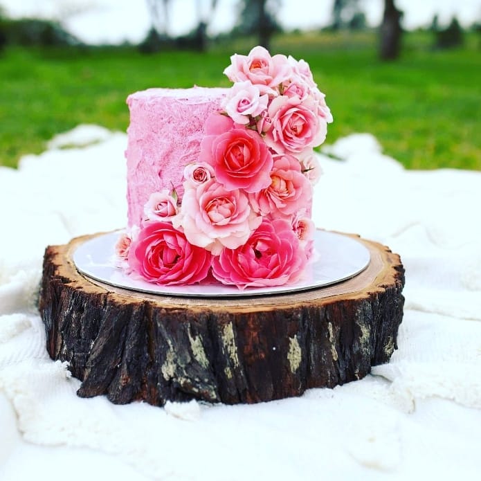 A Cake with Pink Frosting and Pink Roses on A Tree Stump — CK's Milling & Earthworks in Bells Bridge, QLD