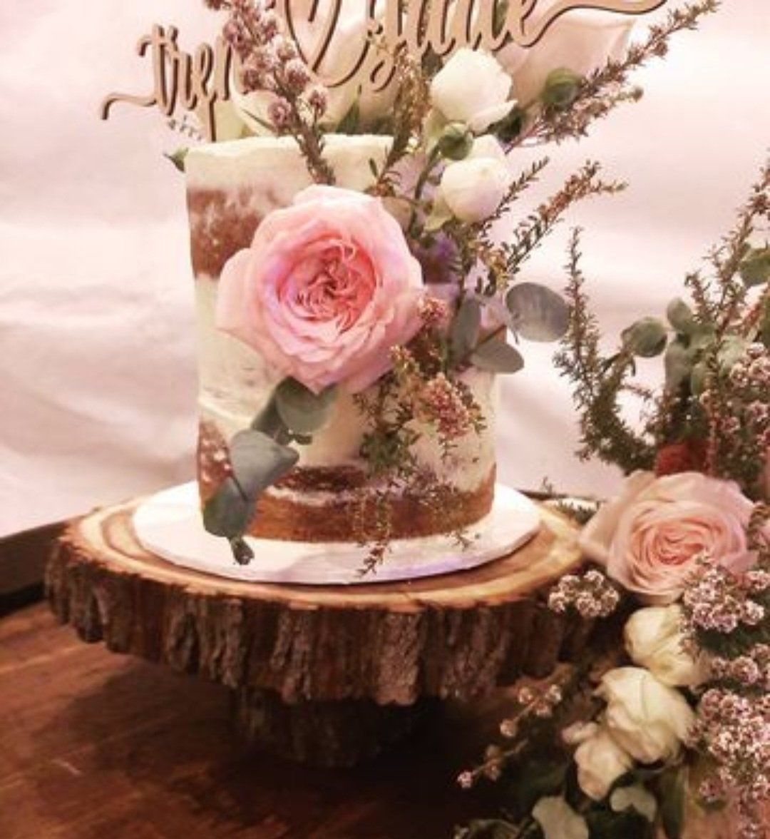 A Cake Sitting on Top of A Wooden Cake Stand — CK's Milling & Earthworks in Bells Bridge, QLD