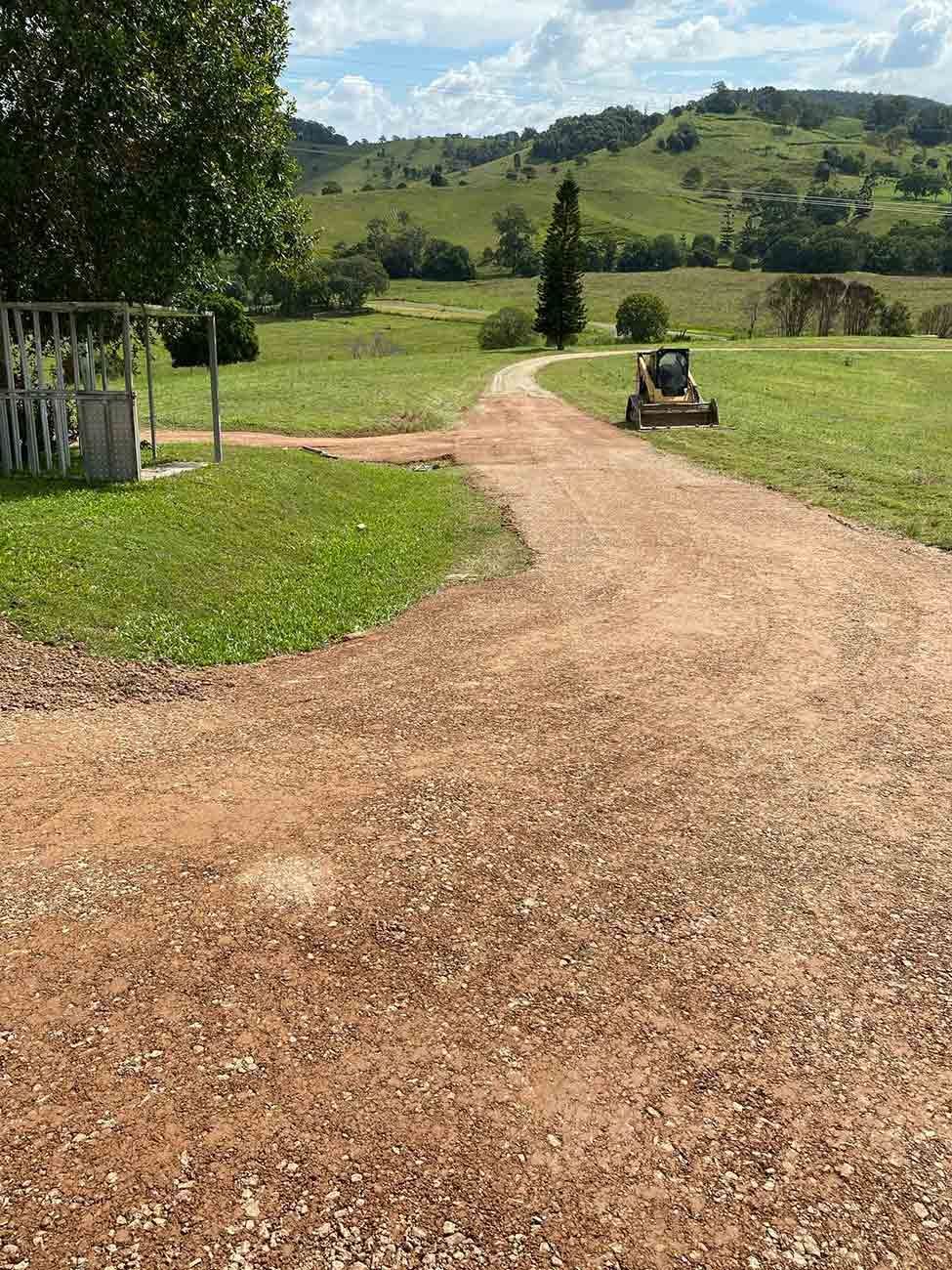 Two Bulldozers Are Working in A Dirt Field with Trees in The Background — CK's Milling & Earthworks in Kilkvan, QLD