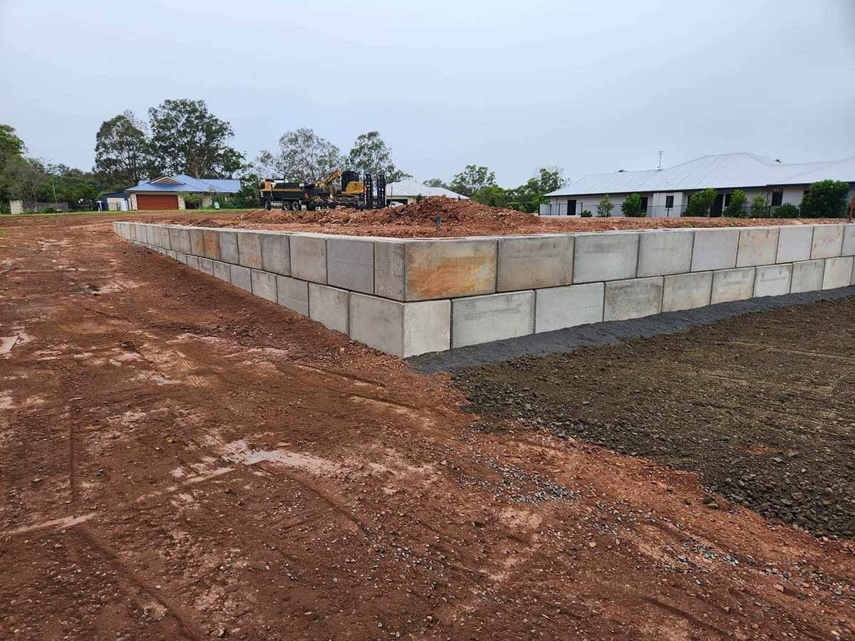 A Concrete Wall Is Being Built in A Dirt Field — CK's Milling & Earthworks in Goomeri, QLD