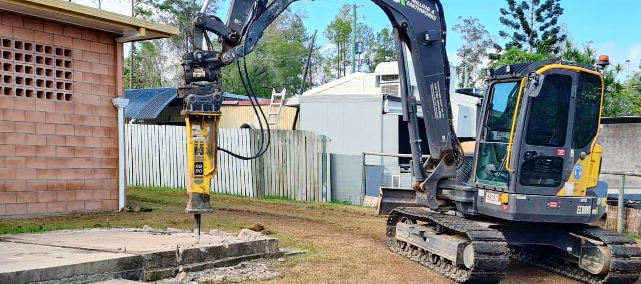 A Group of Construction Workers Are Standing in Front of A Speed Limit Sign — CK's Milling & Earthworks in Veteran, QLD
