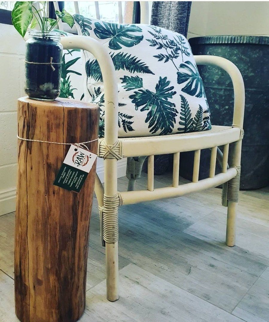 A Chair with A Pillow on It Is Sitting Next to A Wooden Stump — CK's Milling & Earthworks in Bells Bridge, QLD