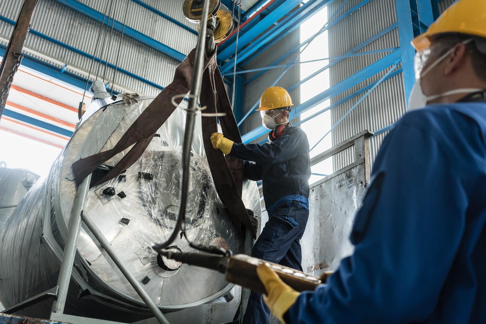 worker putting the rope to the metal