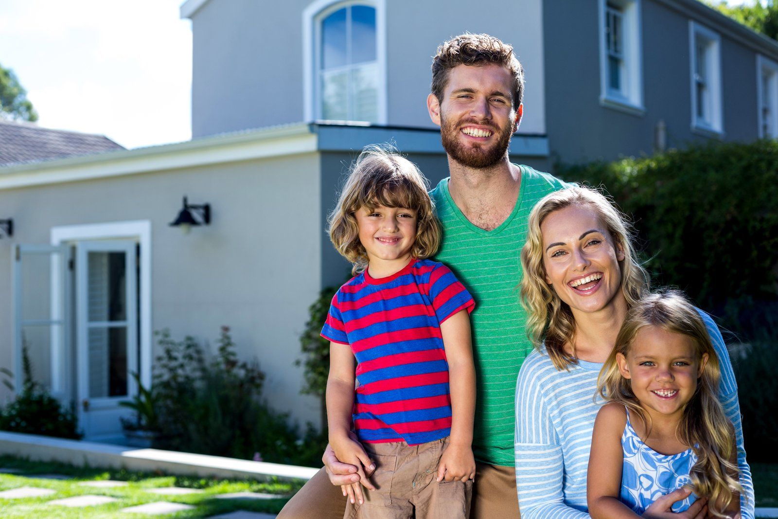 family standing near the house