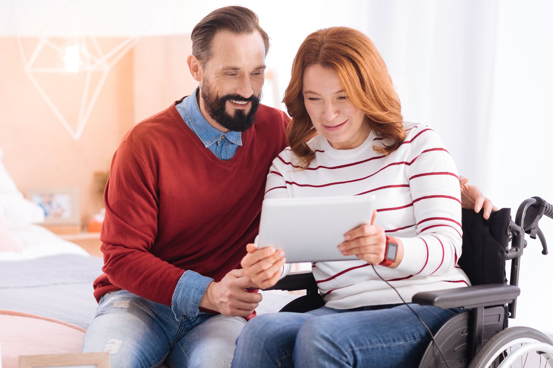 Husband Sitting Next to His Wife on a Wheelchair