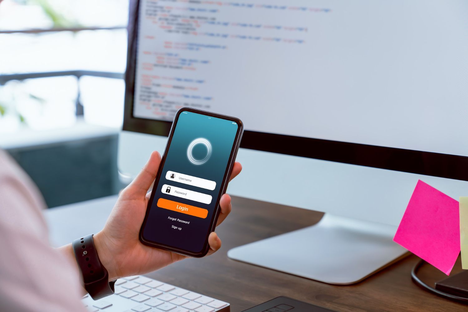 Man on golf course holding phone, looking at course information on app.