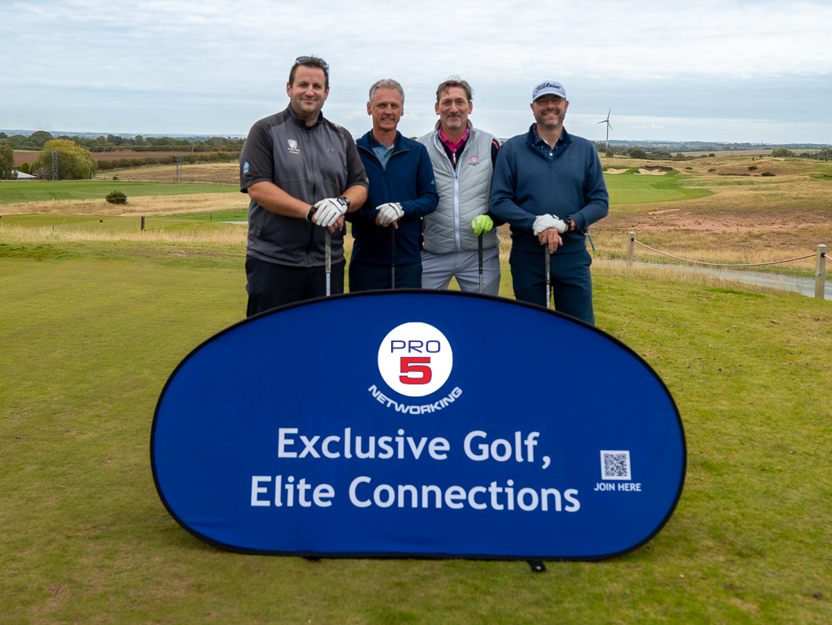 Blue off-road vehicle parked on a sandy beach, facing the ocean on a sunny day.