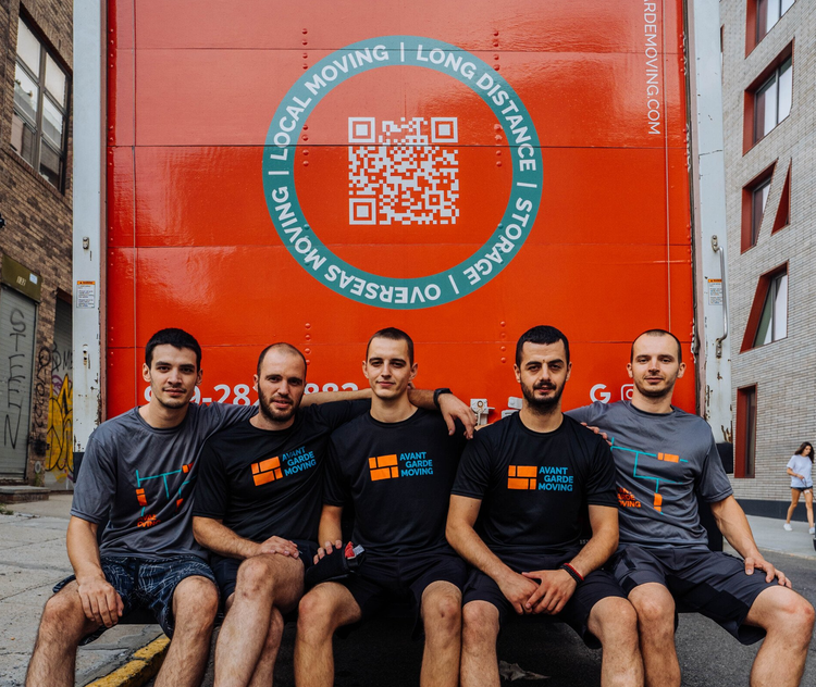 the team sitting on the back of a moving truck