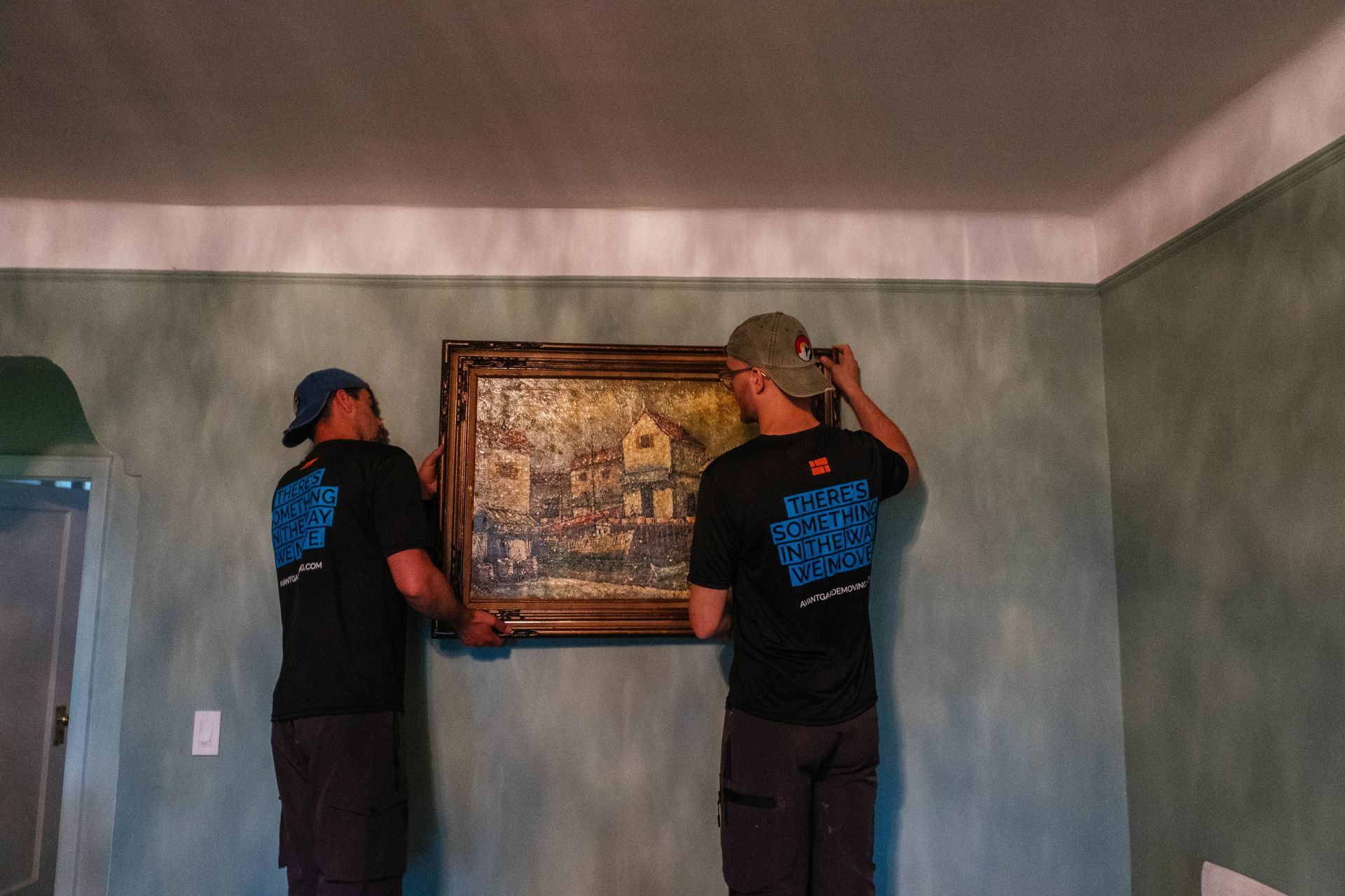 photo of our movers taking the painting from the wall