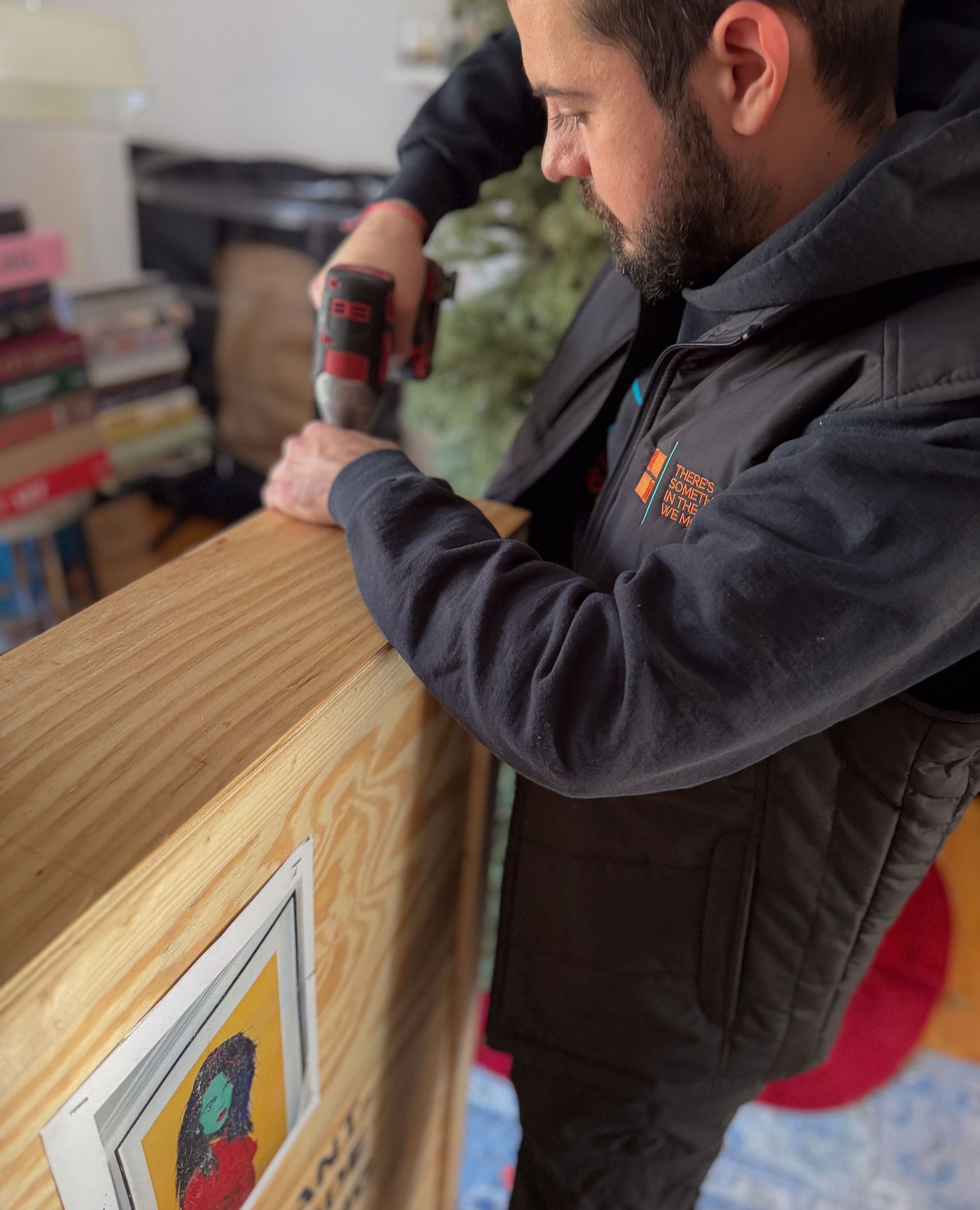 Photo of Avant-Garde fine art mover securely closing a custom-made crate with a drill after carefully placing fine art inside, ensuring safe transport for our fine art moving services.