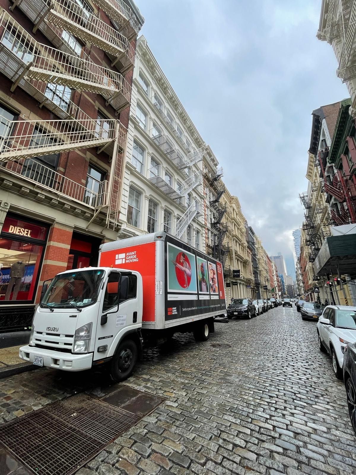avant-grade moving truck parked on Soho street while office move in progress