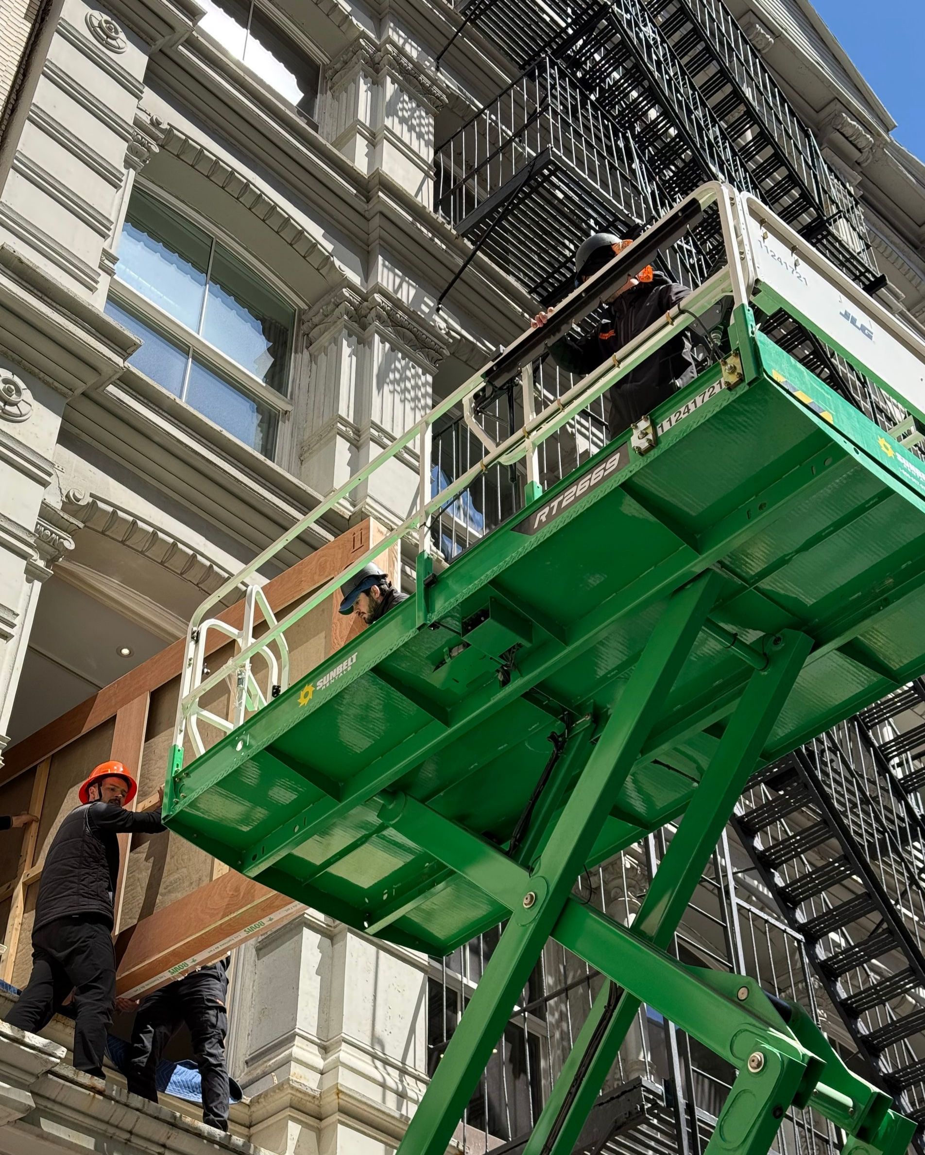 Avant-Garde Moving team delivering a custom-made crate through the window of a Tribeca, Manhattan building during an antique move