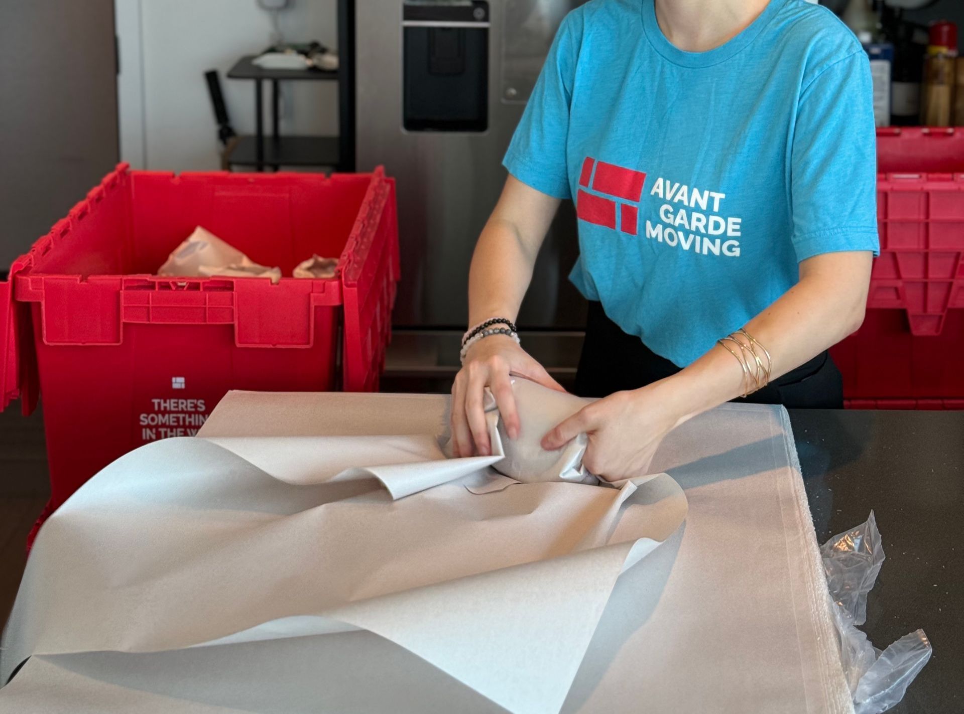 photo of a professional packer packing up dishes and kitchen items 