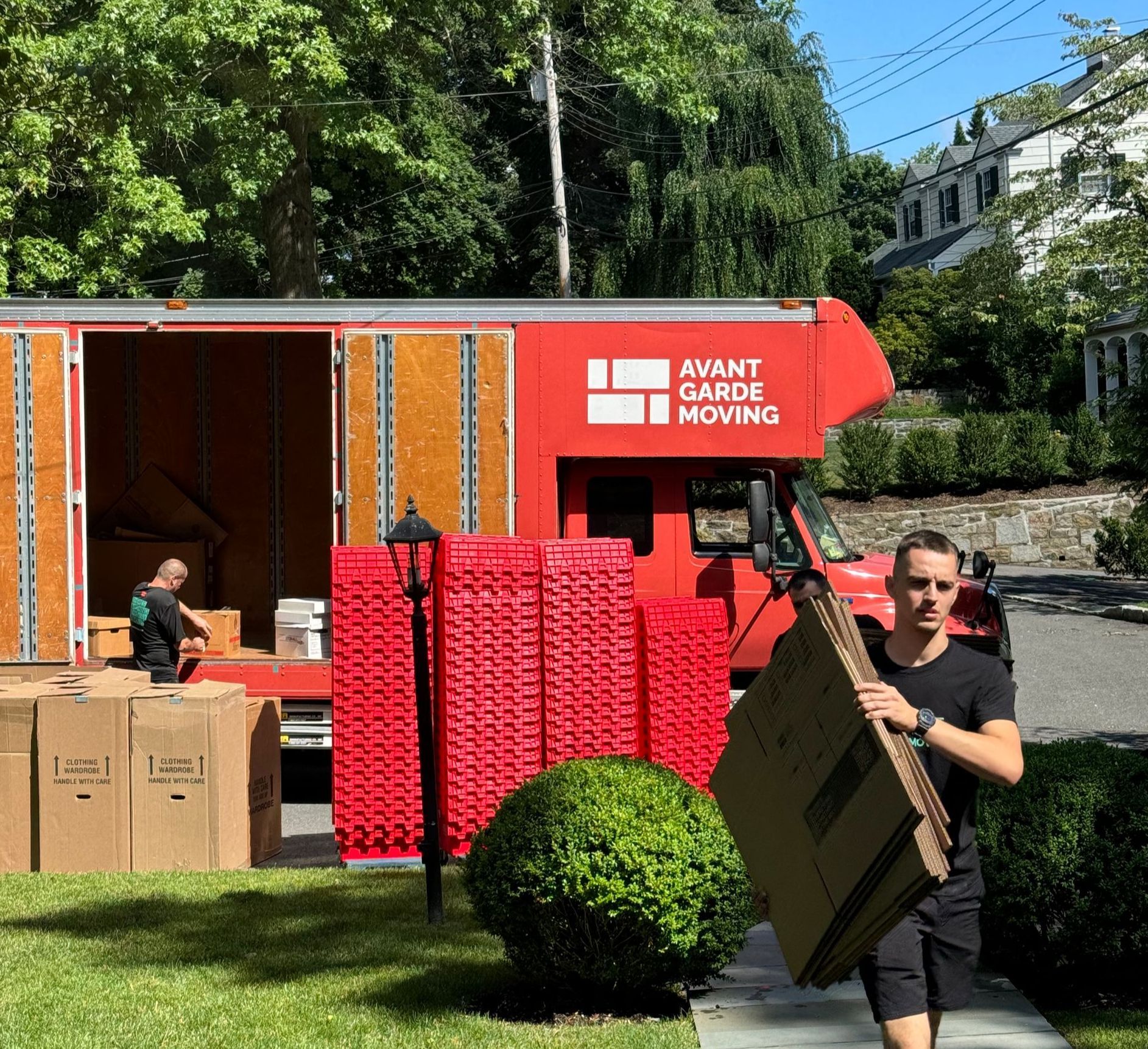 Photo of avant-garde mover taking packing material (boxes) into the customers house 