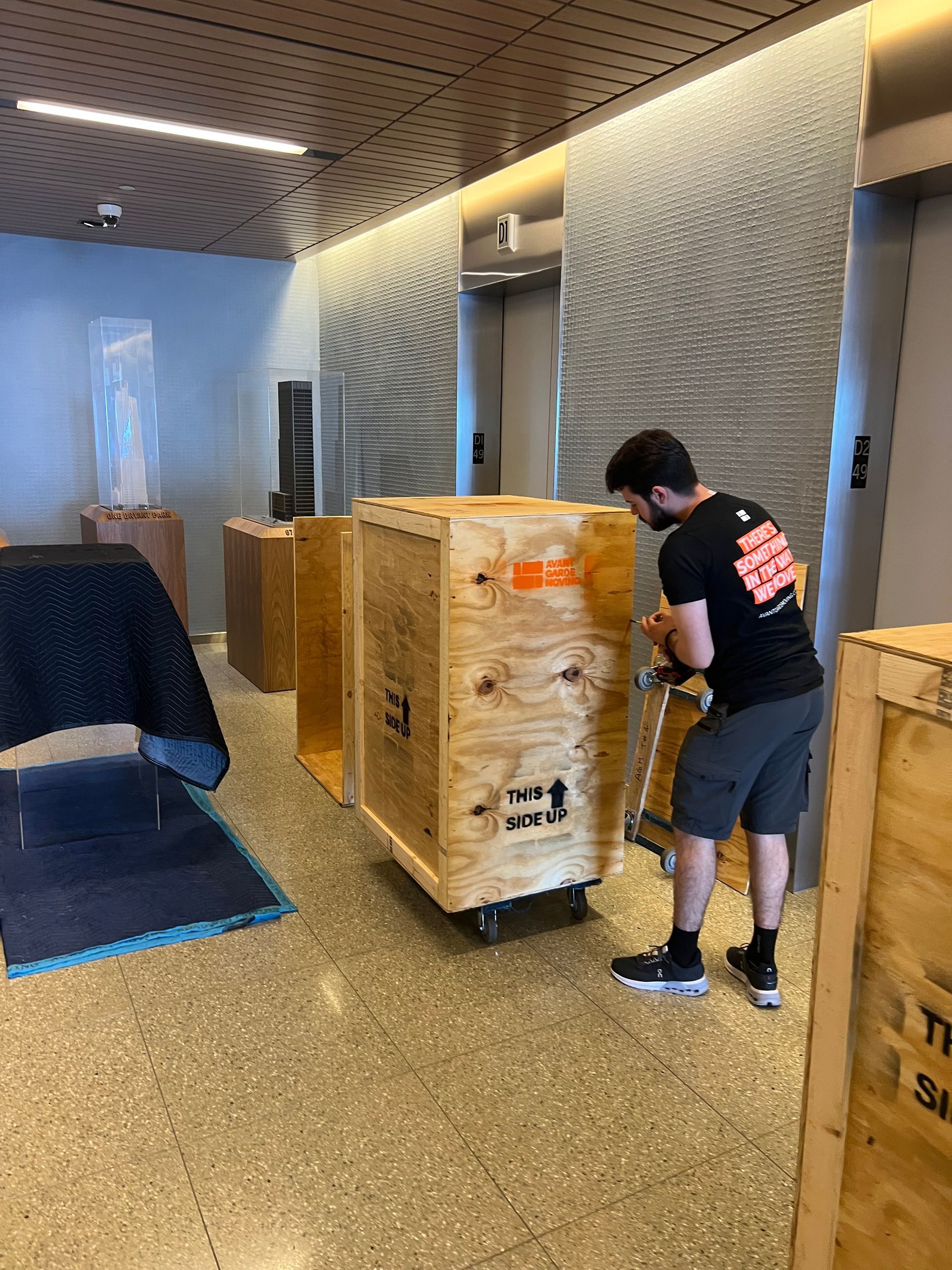 Photo of avant-gadre mover closing up custom made crate for some valuable sculptures from a NYC office