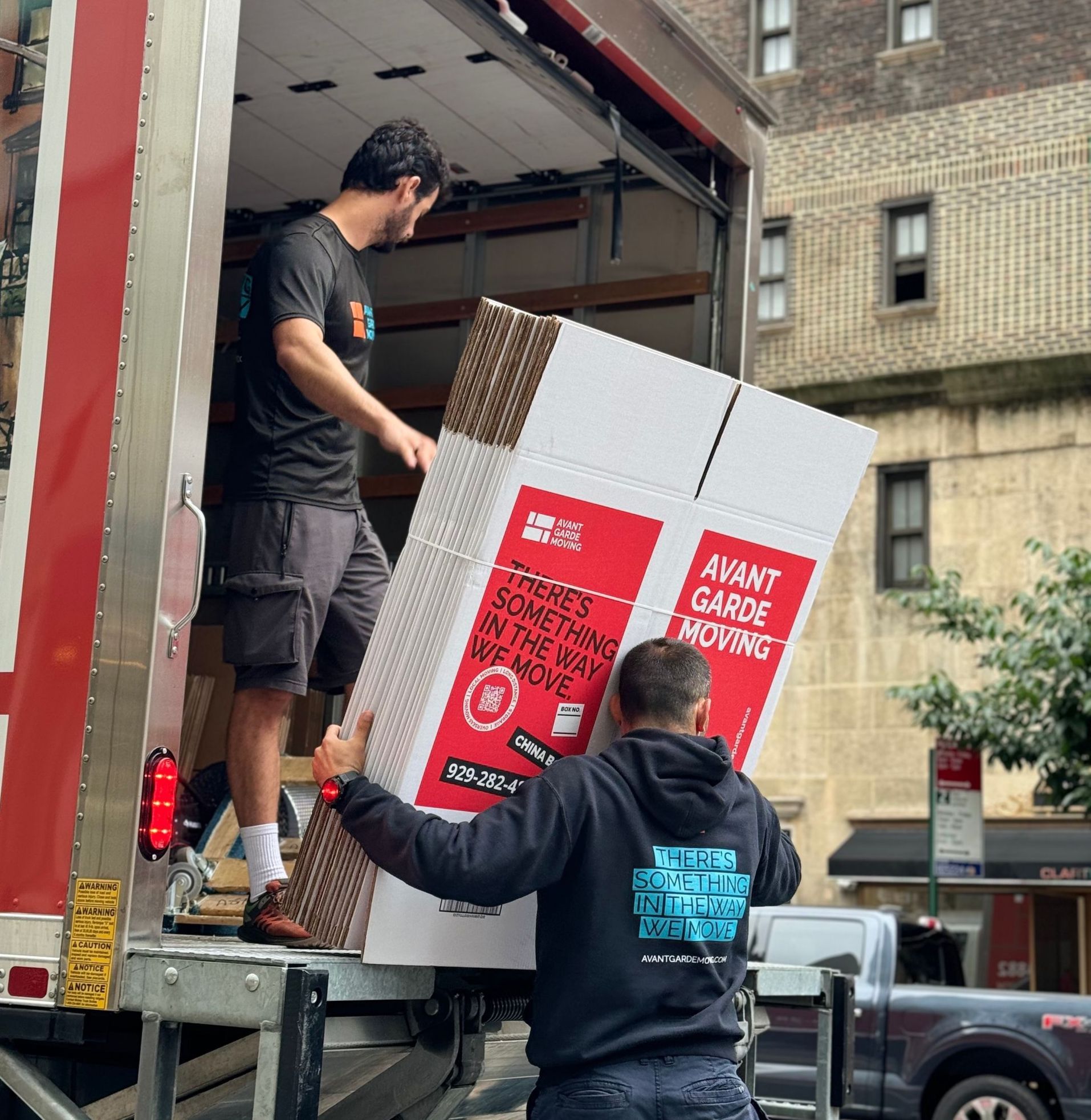 snapshot of our NYC movers unloading boxes from the truck in Manhattan