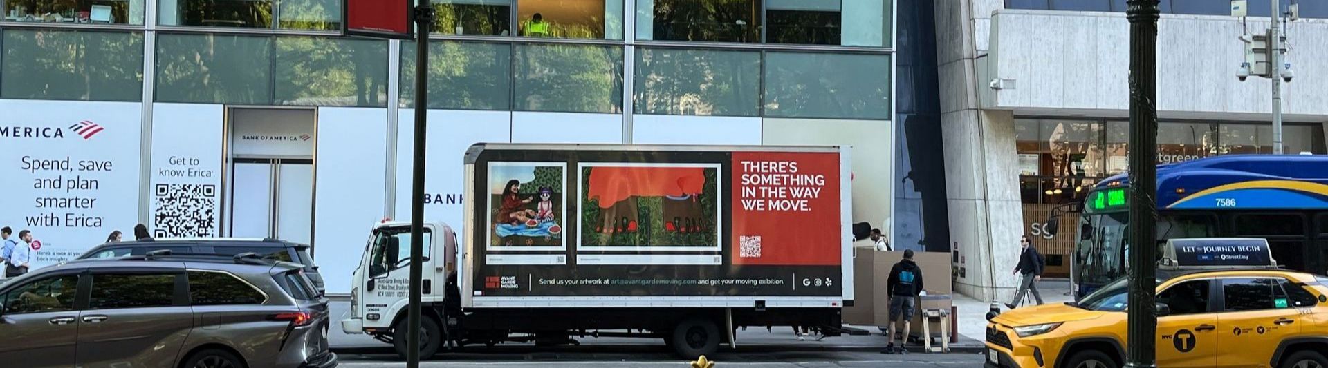 Photo of Avant-garde Moving truck and movers parked in front of the Bryant Park in NYC; getting ready to start a move in a nearby building 