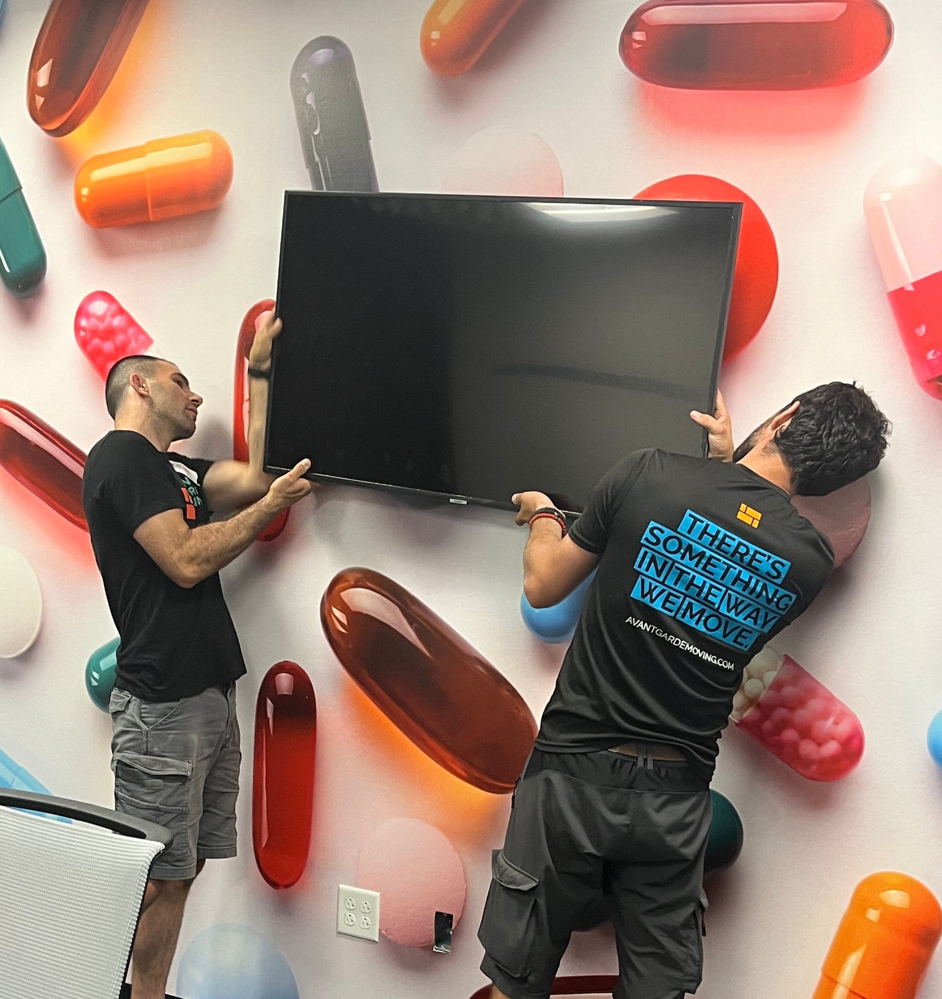 Photo of Avant-Garde Movers mounting the TV on the wall