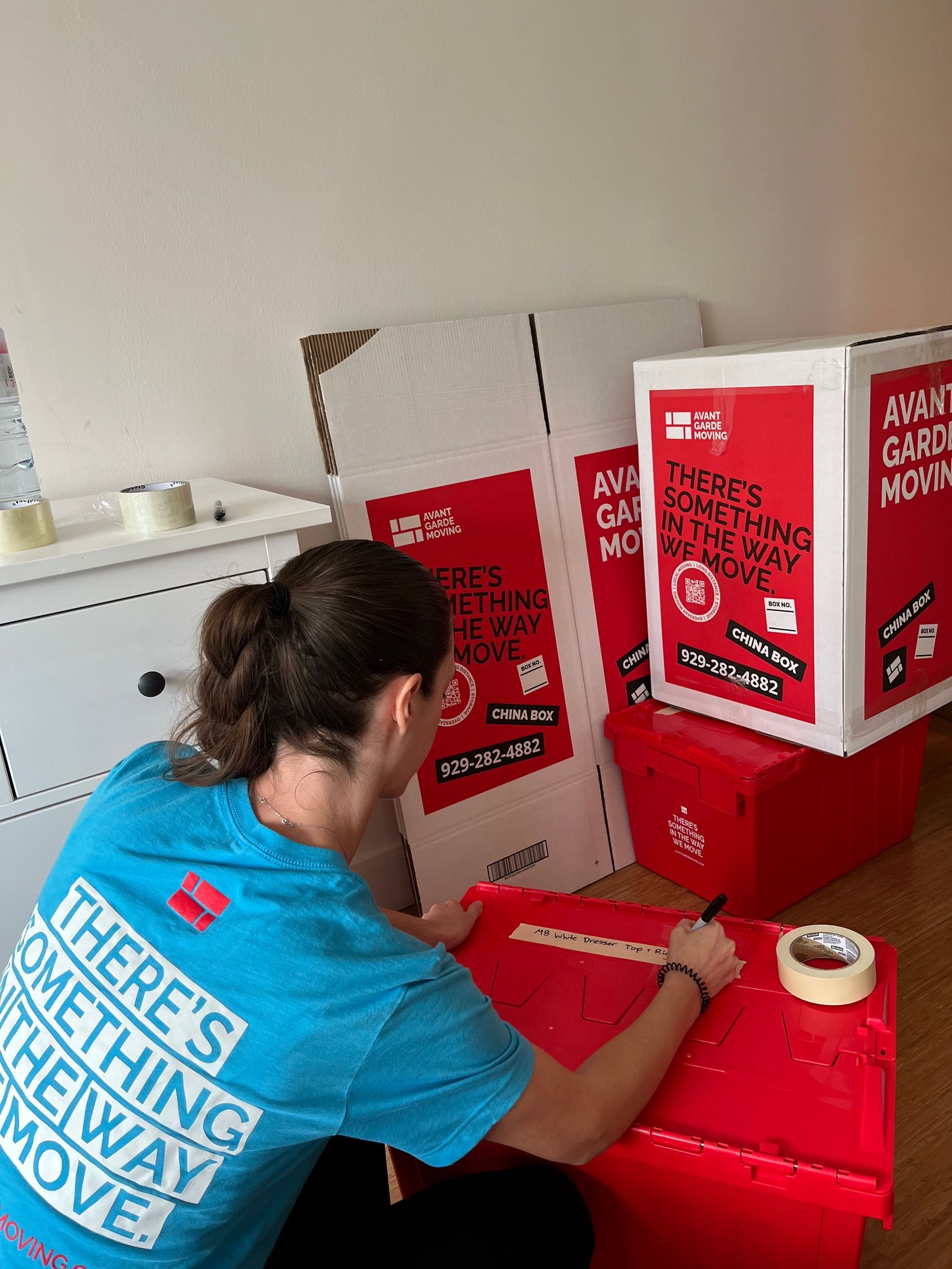 Photo of our packer/organizer packing up and labeling boxes in a master bedroom