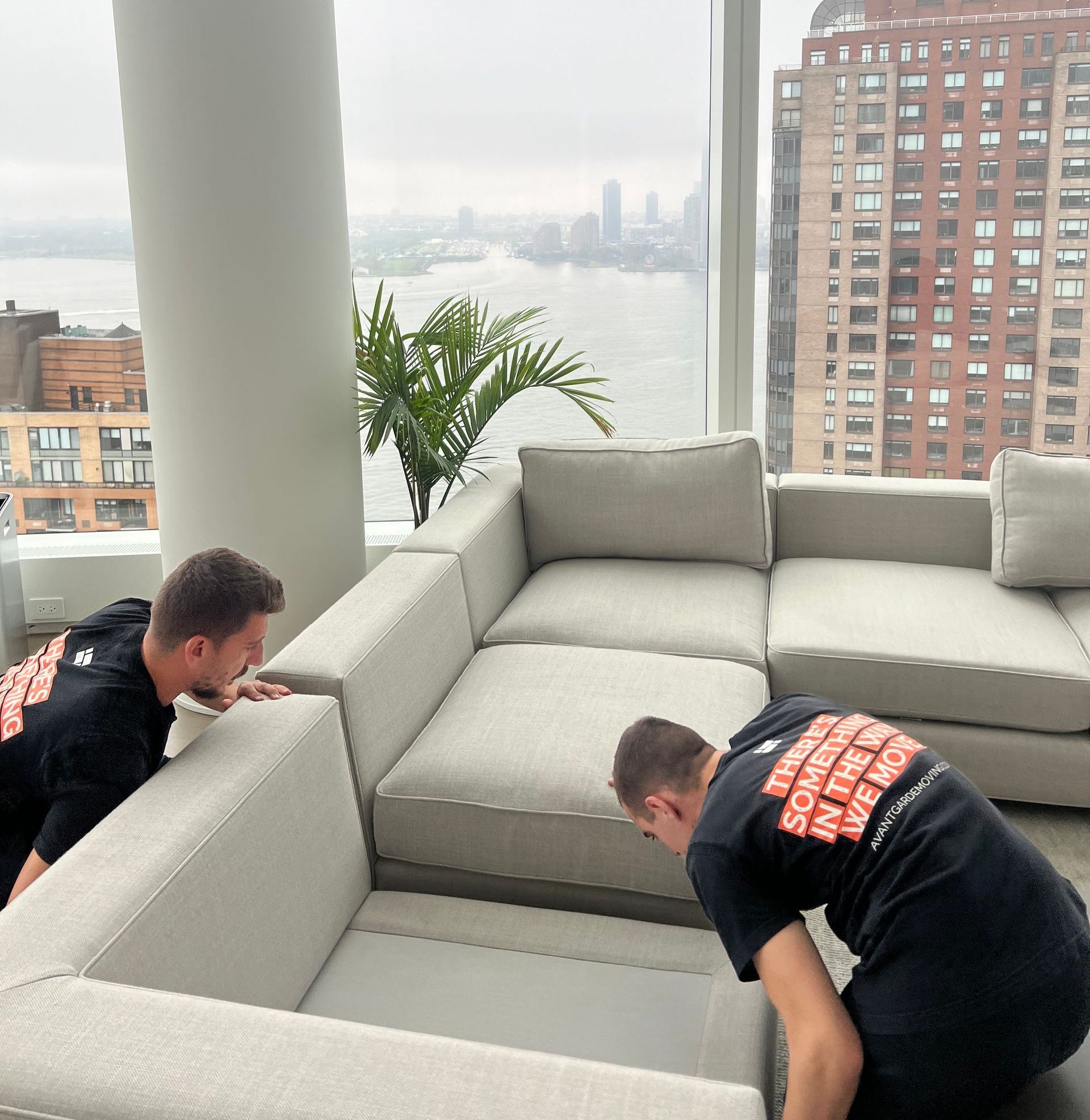 Photo of Avant-Garde movers assembling the sectional sofa back together 