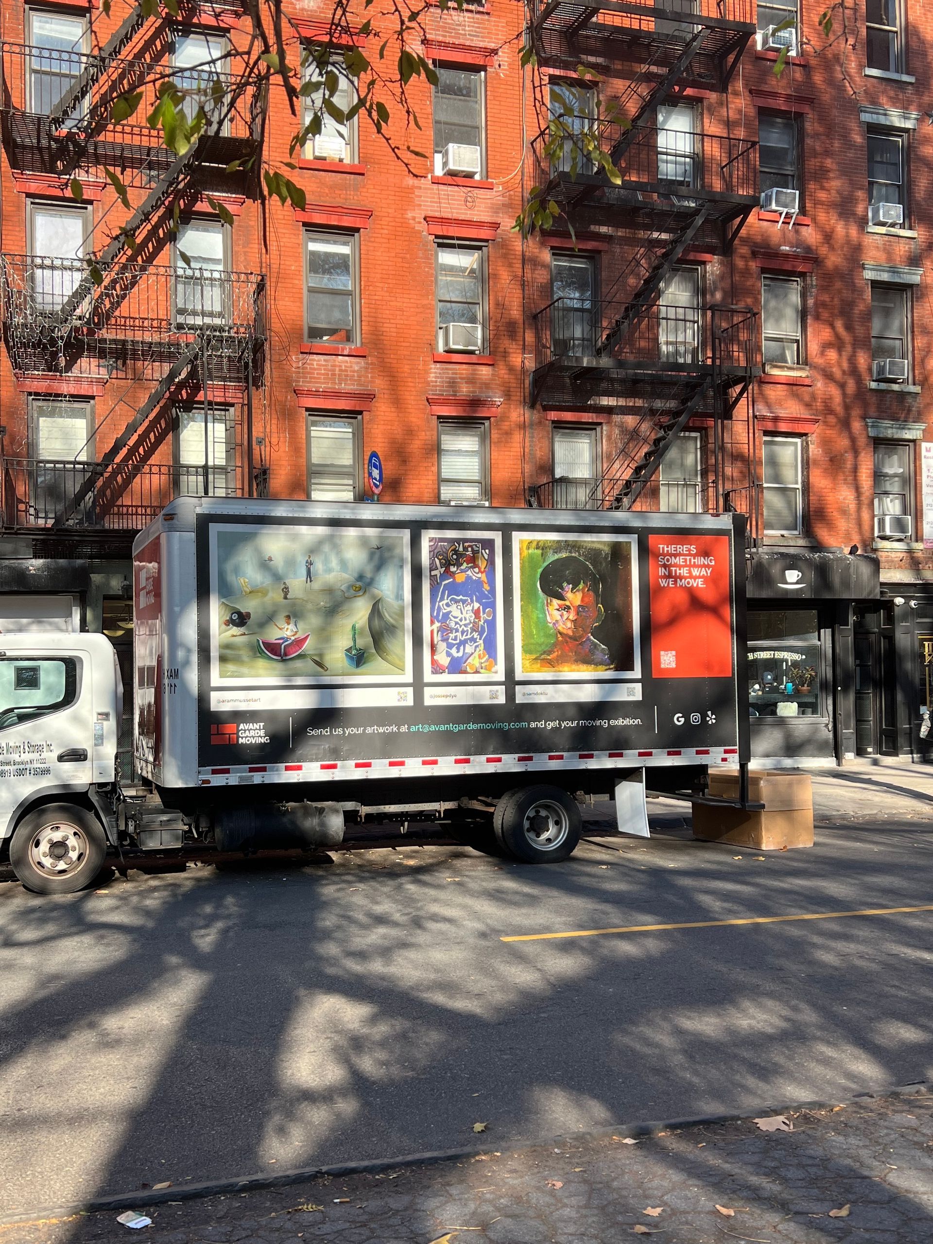Photo of our truck parked on the street, with the paintings on it visible