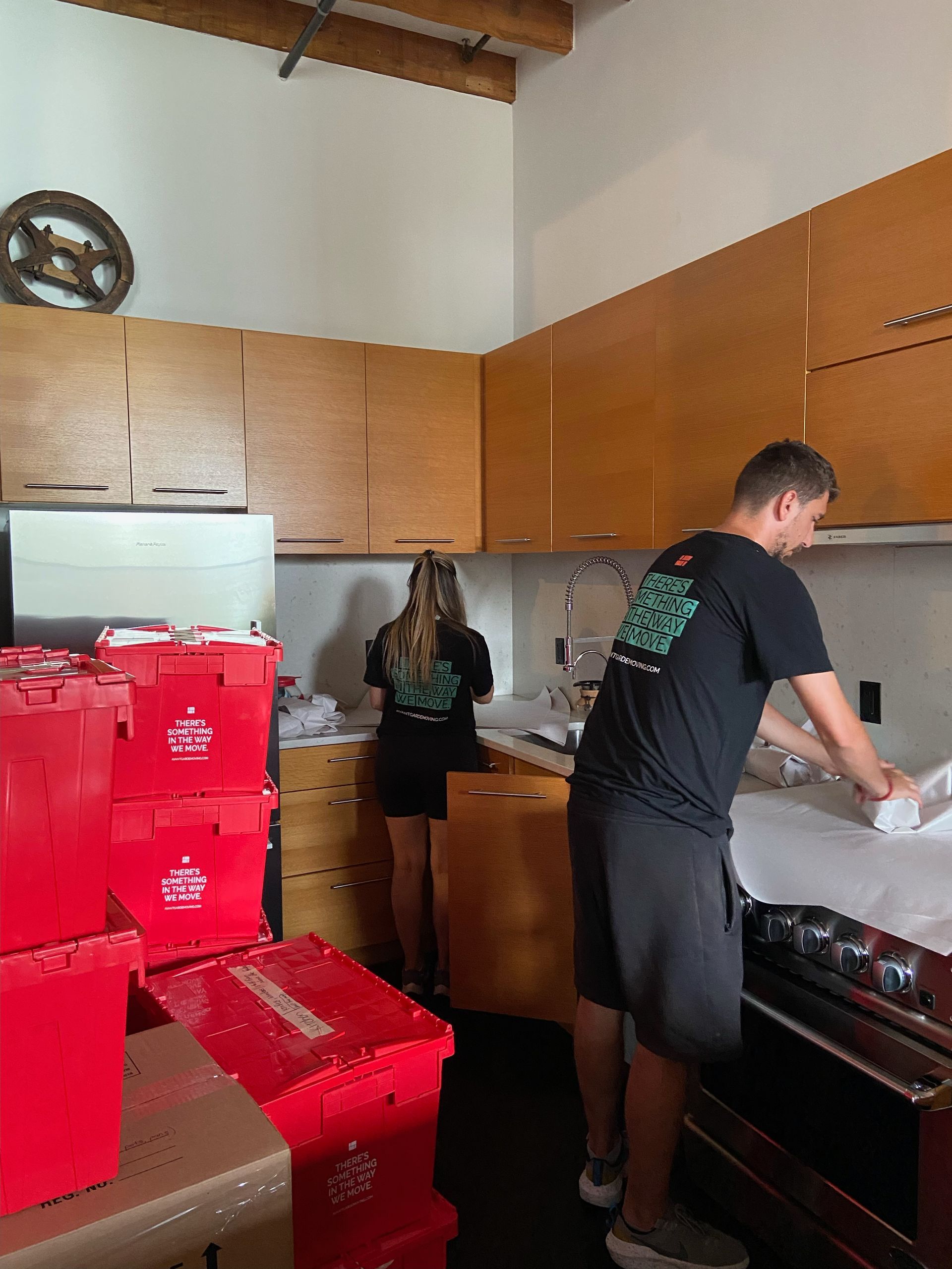 movers and packers packing up kitchen 