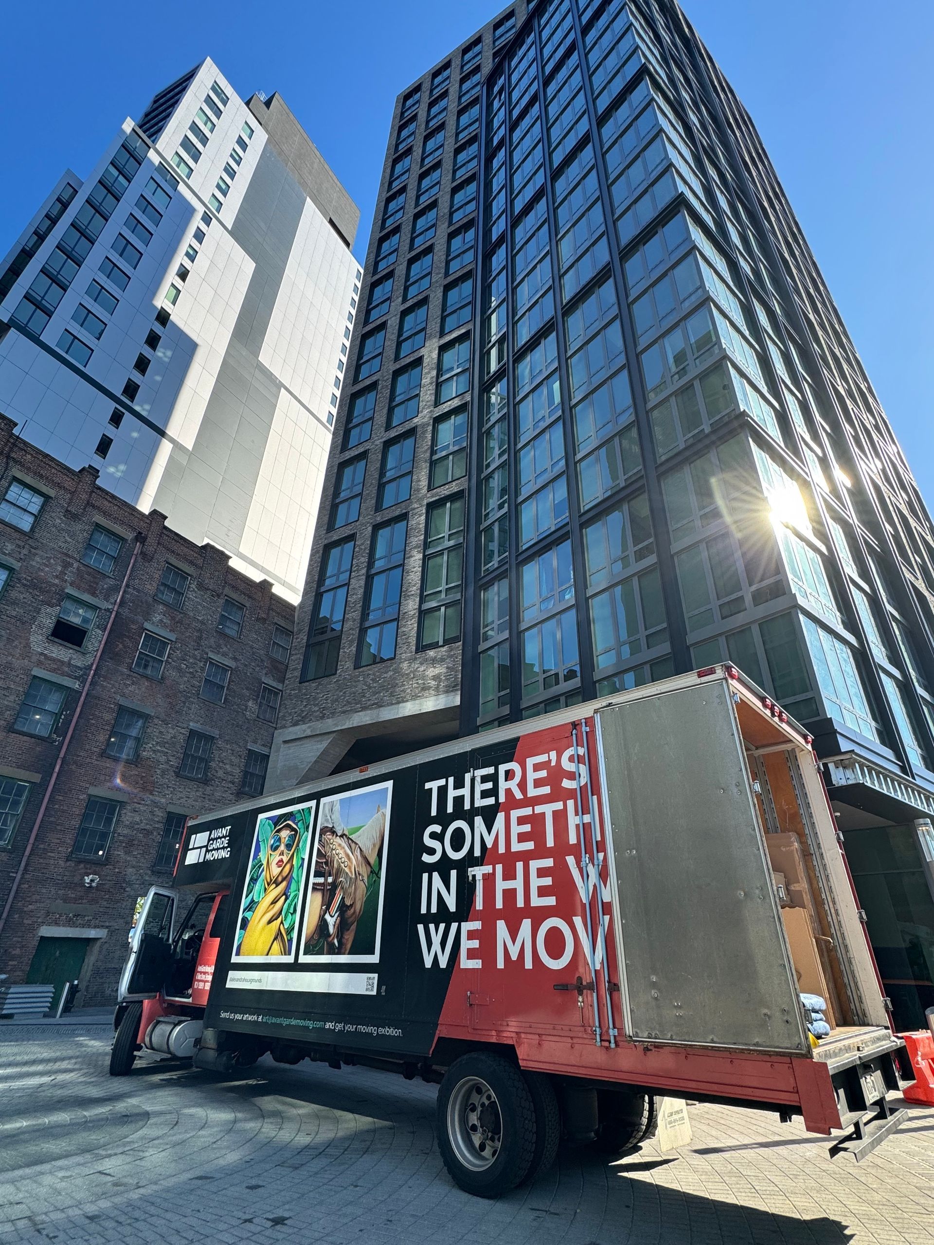 avant garde moving truck outside a modern building