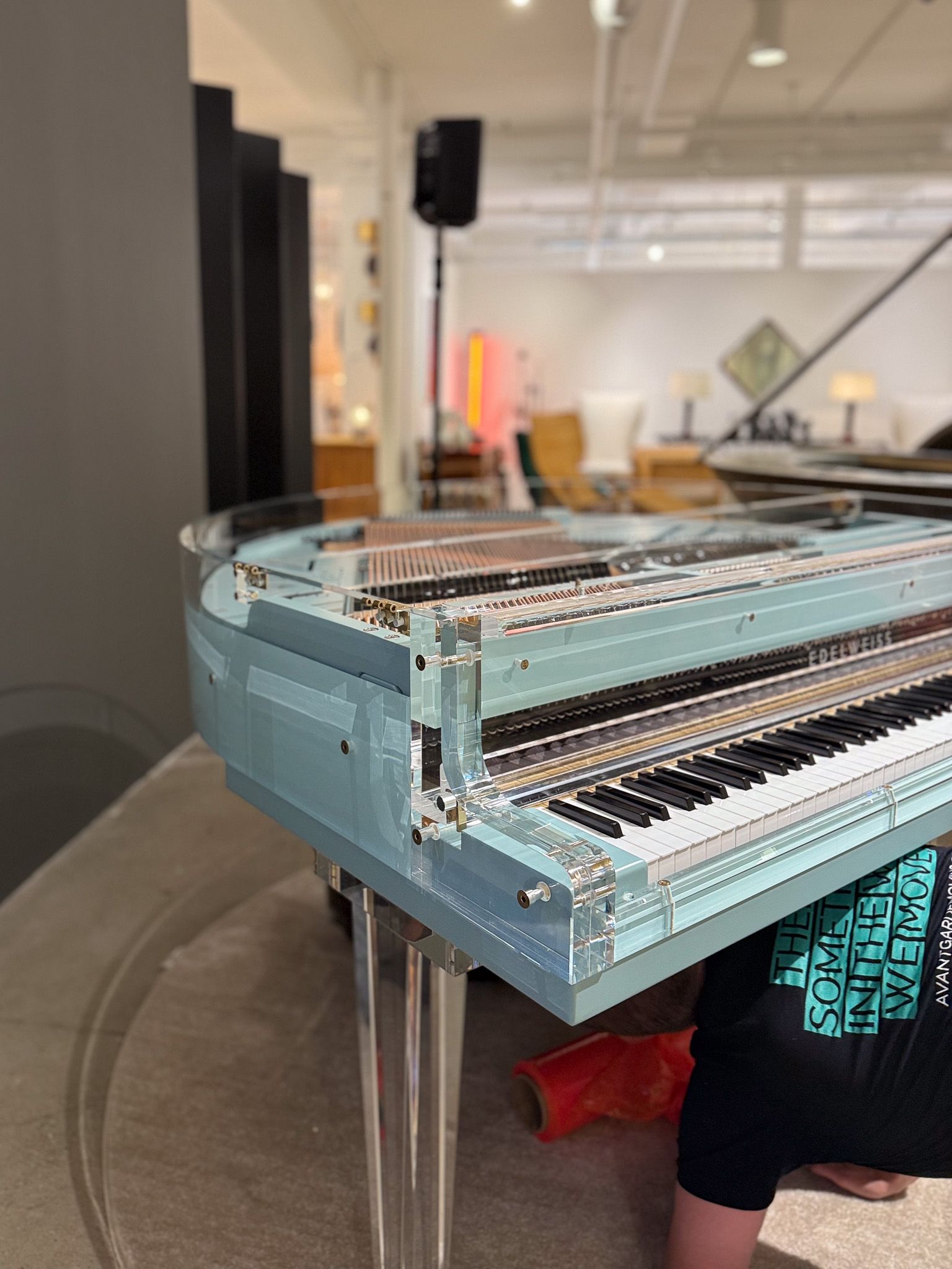 Photo of our professional piano movers making sure baby grand piano is tuned perfectly upon delivery